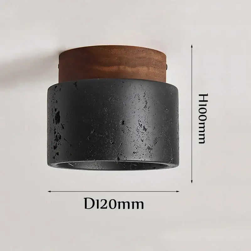 Rustic black travertine ceiling light featuring a black textured concrete wall sconce with a warm brown wooden top