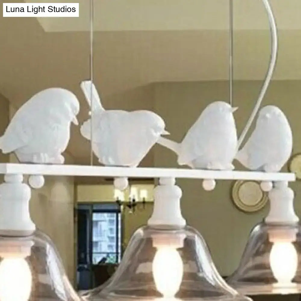 White ceramic bird pendant light fixture with clear glass shades in rustic black for kitchen lighting by DecorBites