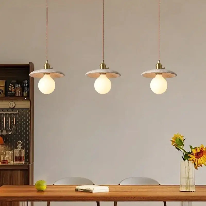 Three rustic brass and ceramic glass ball led pendant lights with white disc-shaped shades for dining room decorbites glass ball