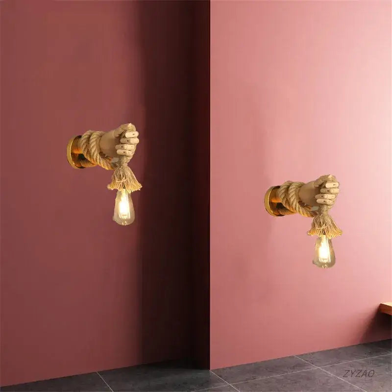 Rustic brass hand shape wall lamp with hemp rope wrapped arms and hanging filament bulbs for bedroom wall light