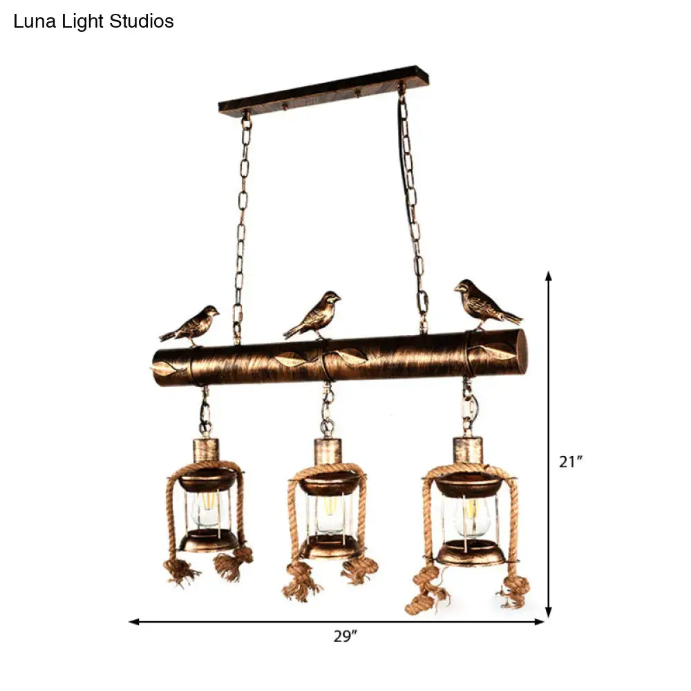 Bronze finished rustic metal caged island pendant light with three lanterns rope detailing and decorative birds by decorbites