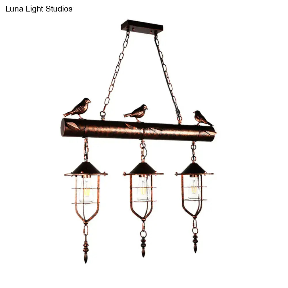 Bronze finished decorbites coastal style metal caged island pendant light with three lanterns and birds on wooden beam