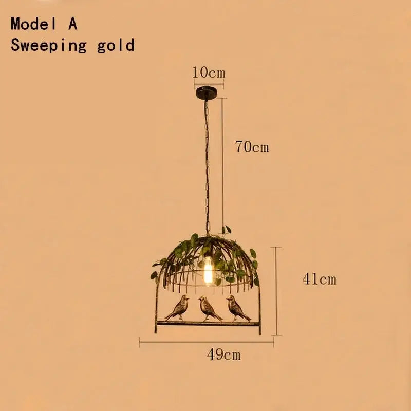 Rustic bronze iron bird cage chandelier with sweeping gold pendant light featuring three iron birds and greenery decorbites iron bird cage decor