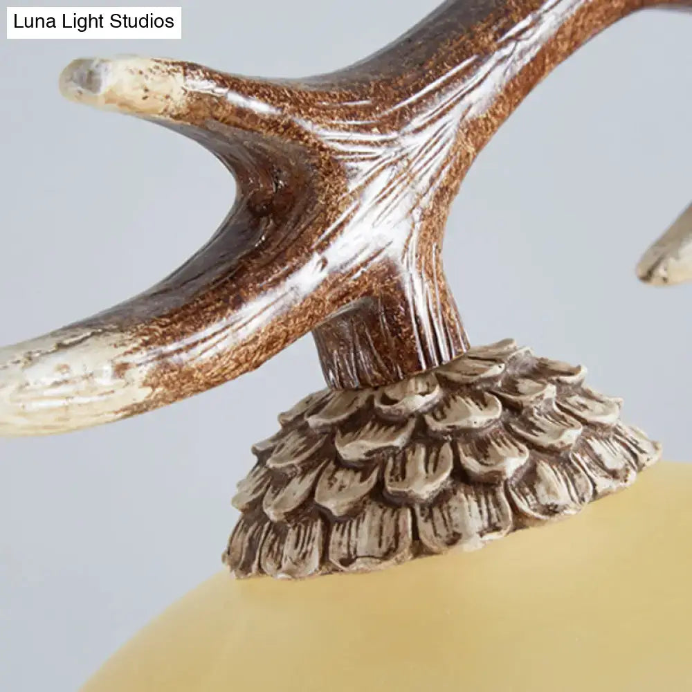 Antler-shaped distressed brown and cream lamp finial with ridges on bulb base of decorbites traditional ceiling light