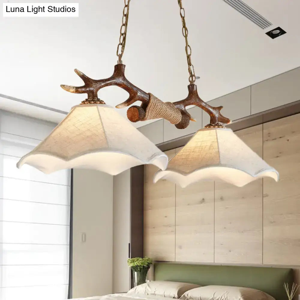 DecorBites traditional bell ceiling light with antler arm and two cream scalloped flaxen fabric bulb shades suspended by brass chains