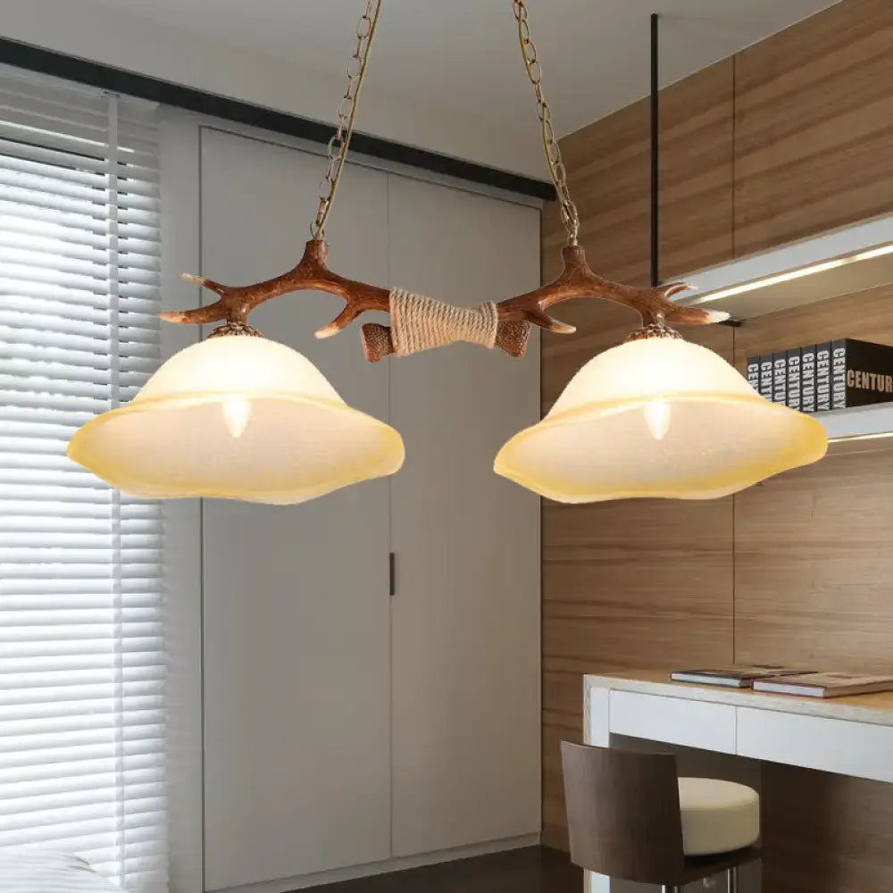 Decorbites 2-light traditional bell glass island pendant in brown with antler-themed wooden branch and warm incandescent shades