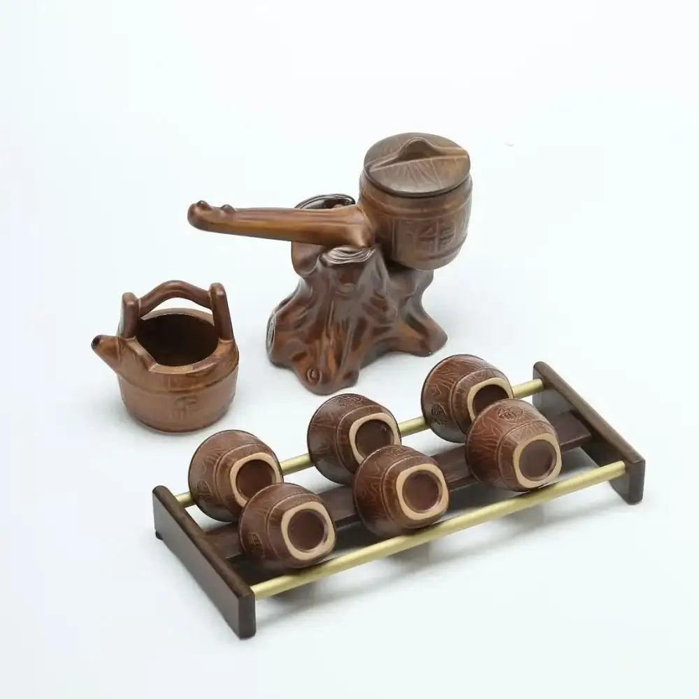 Rustic brown ceramic tea set with tree root styled water dispenser small teapot and six cups on wooden brass rack for tea brewing decorbites ceramic kung