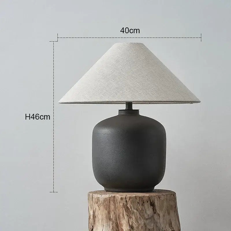 Dark gray ceramic wabi sabi floor lamp with textured rounded base and light beige linen shade for living room decorbites