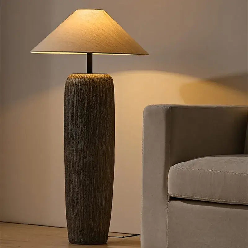 Rustic dark brown ceramic wabi sabi floor lamp with textured base and beige conical fabric shade for living room decorbites