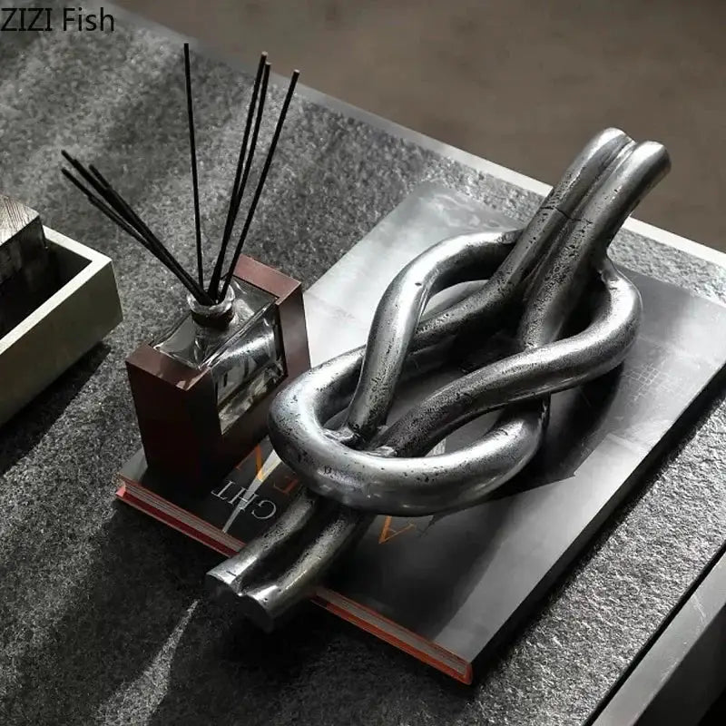 Rustic dark metal geometric knot resin sculpture with silver-toned textured finish for living room decorbites geometric knot