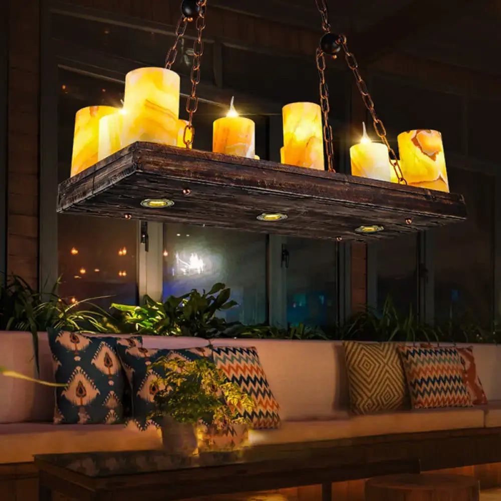 Rustic dark wood and amber alabaster candle light fixture ceiling light suspended above a cozy seating area 220v-240v
