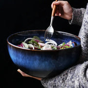 Rustic deep blue ceramic salad bowl with textured handcrafted finish and wooden-handled fork for dining room decorbites ceramic porcelain
