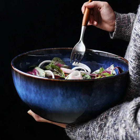 Rustic deep blue ceramic salad bowl with textured handcrafted finish and wooden-handled fork for dining room decorbites ceramic porcelain