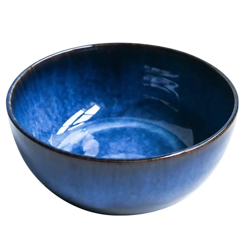 A deep blue ceramic porcelain salad bowl with glossy gradient finish and subtle speckled texture for dining room decorbites
