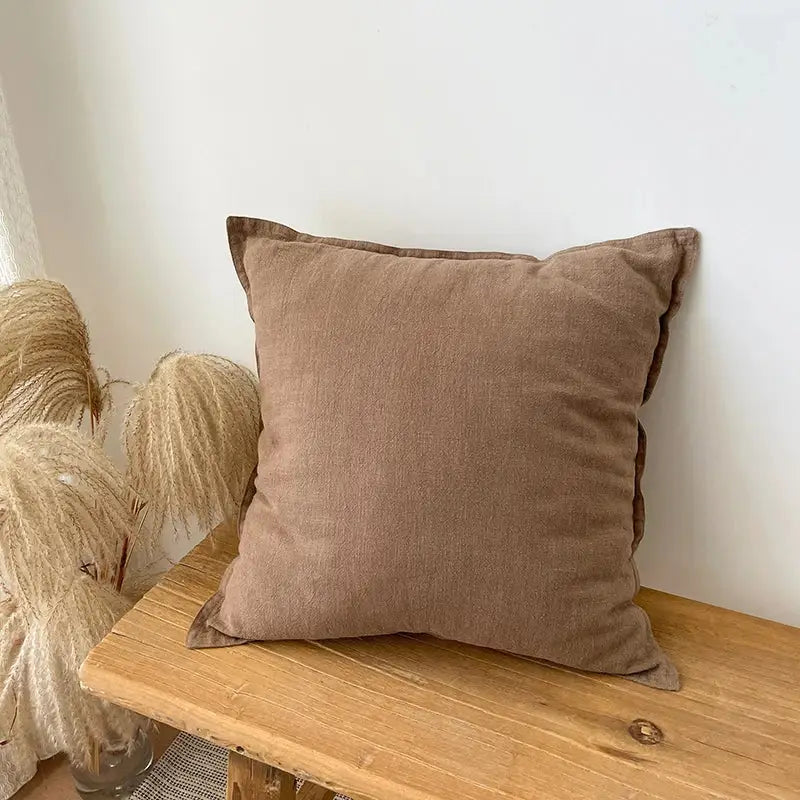 A soft brown linen fringed pillow cover with subtle texture for rustic earthy tones living room decor by decorbites