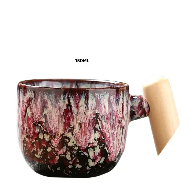 A 150ml ceramic latte mug with deep red pink cream marbled glaze and a light wooden handle for rustic kitchen use