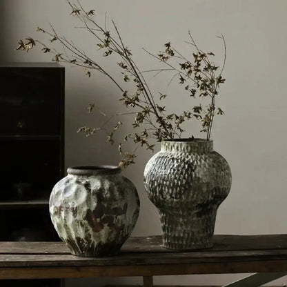 Two rustic coarse pottery vases with distressed green and brown patina on wood for home decorbites home decor