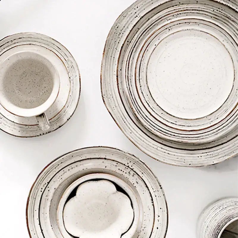 Rustic grayish white stoneware dish bowl set with speckled glaze and concentric ridged rims for dining room use