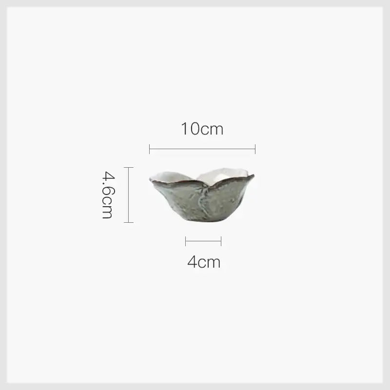 A delicate handcrafted rustic grayish white ceramic dish bowl set with soft gray glaze and textured ridges