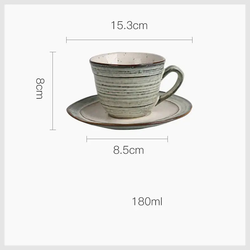 Rustic grayish white ceramic dish bowl set featuring a speckled sage green teacup with horizontal ridges on a matching saucer