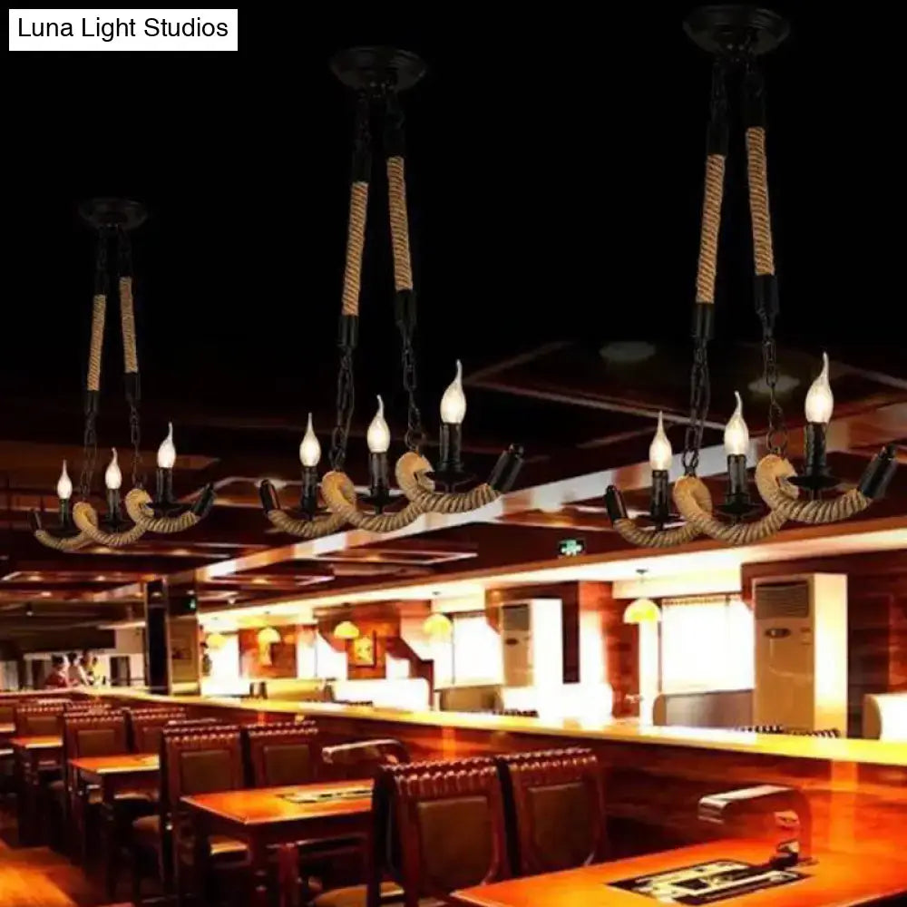 Black metal ceiling light with natural rope accents and three candle-style bulbs designed for island lighting