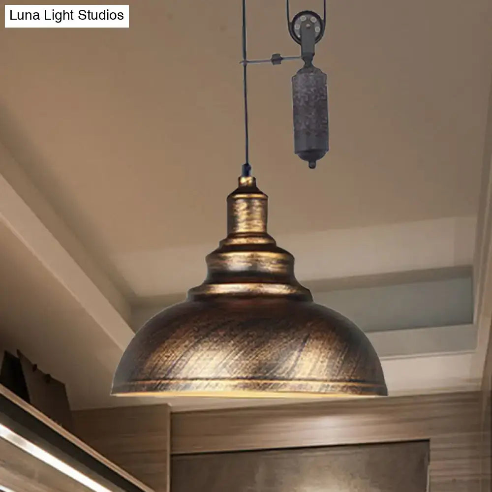 Antique brass-finished rustic industrial dome pendant lamp with pull-chain and textured metal shade for living room lighting