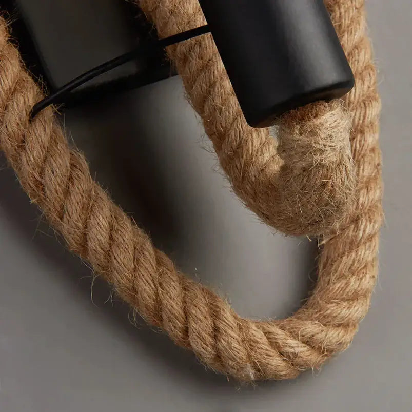 Rustic industrial hemp rope wall lamp with thick natural beige hemp rope threaded through black fixtures