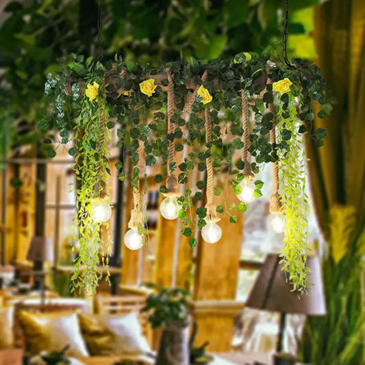 Rustic iron rose pendant light fixture with yellow roses and green vines, hanging by thick rope chain cord length