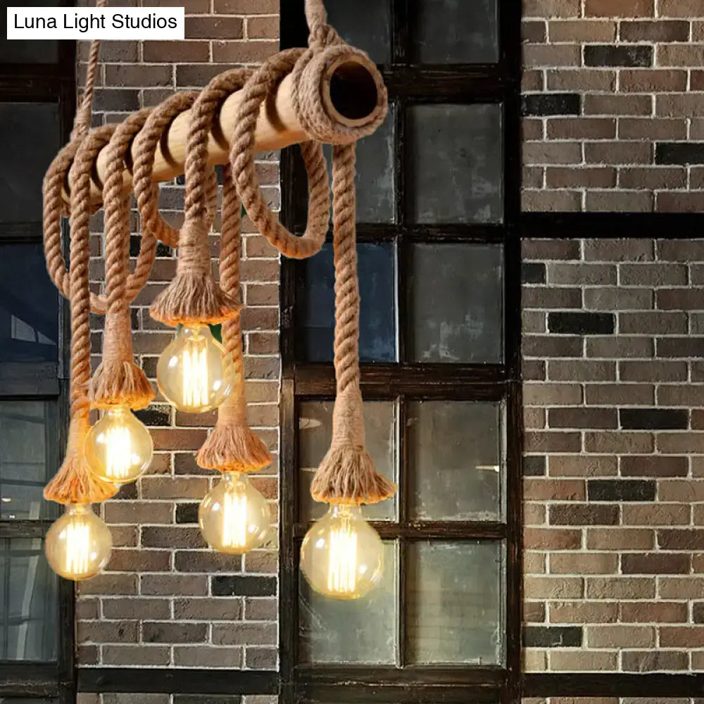 Rustic industrial island light with adjustable beige rope and bamboo structure featuring exposed filament bulbs