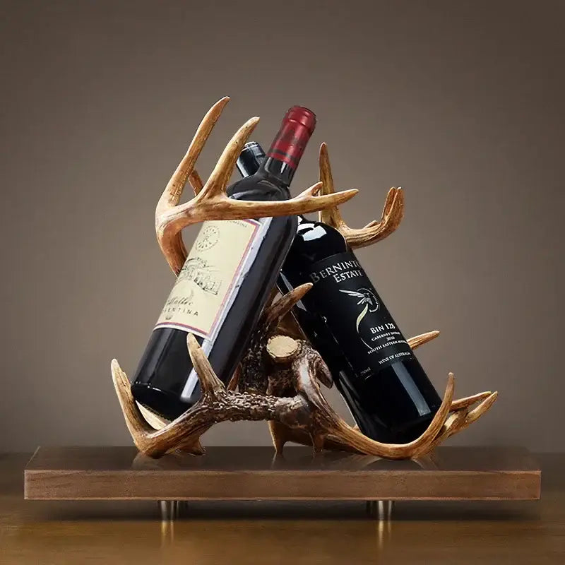 Rustic natural resin buckhorn wine holder with antler design in natural finish holding two dark glass bottles for decorbites wine holder