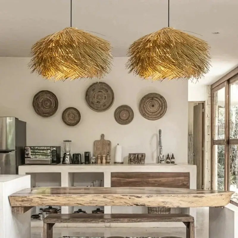 Two golden pendant lights with natural straw shade hang from ceiling to bring warmth to dining rooms