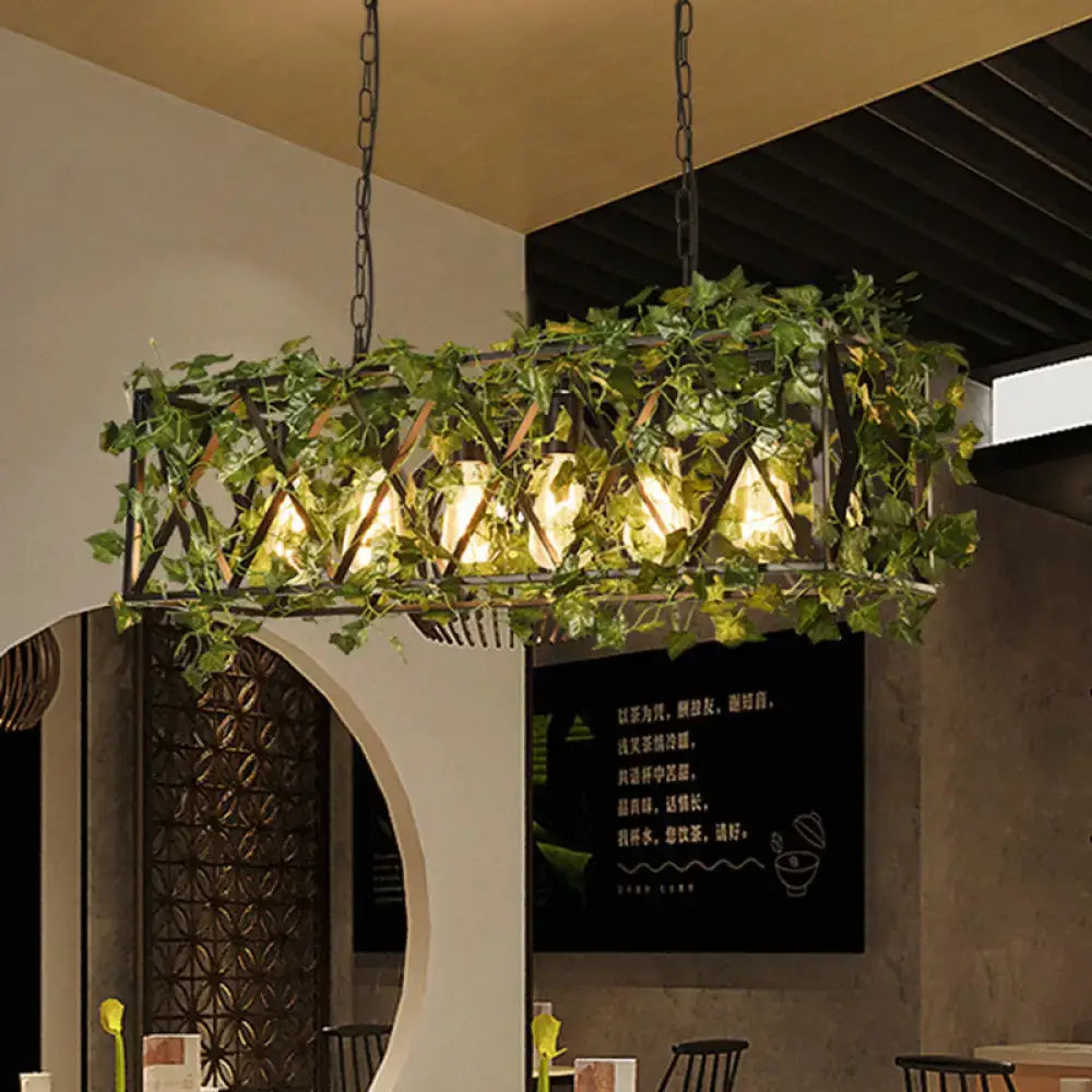 Black metal rectangular island ceiling light with red green ivy accents and warm glowing 6-headed industrial LED design