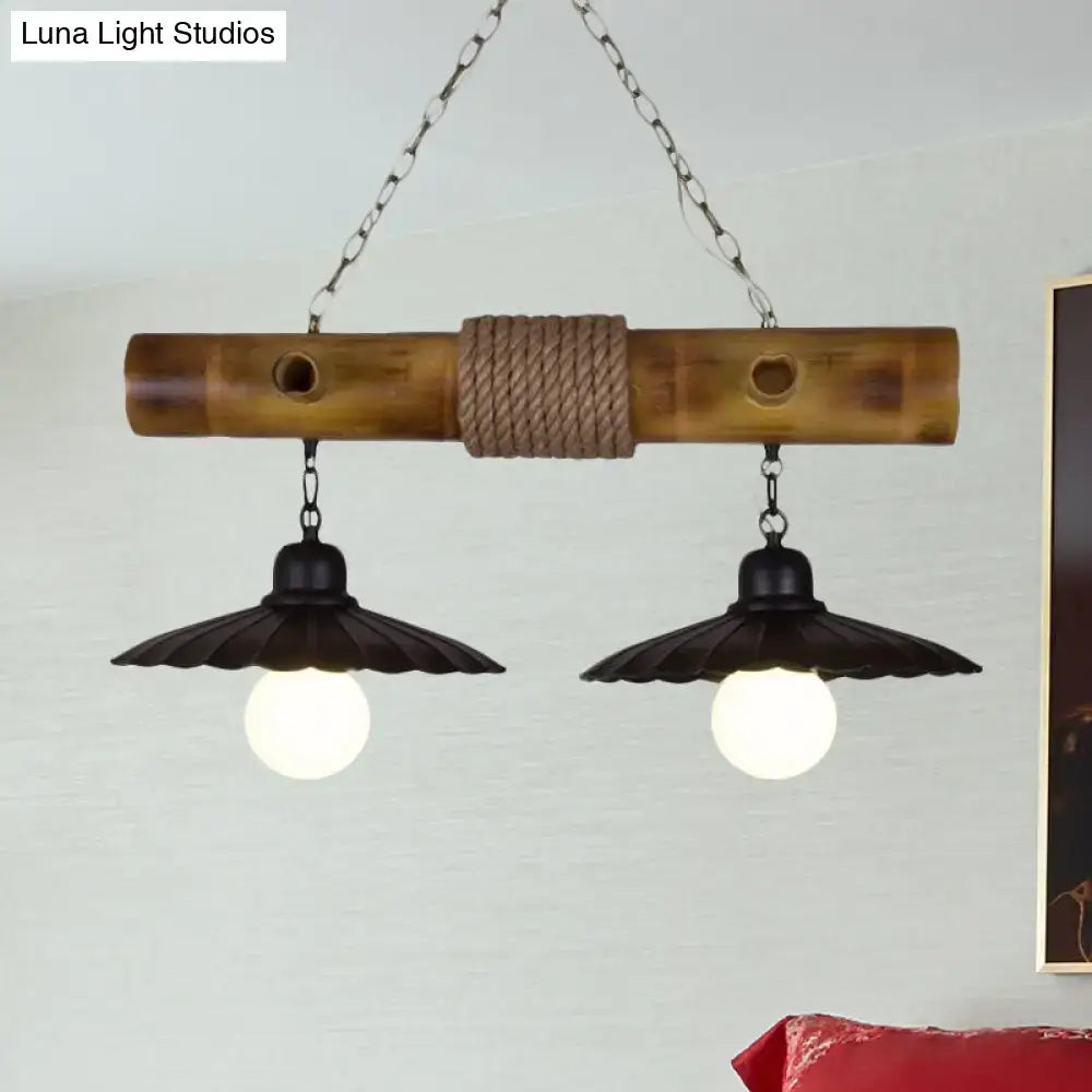 Rustic scalloped hanging lamp with black metal shades and rope-wrapped bamboo center for dining room lighting