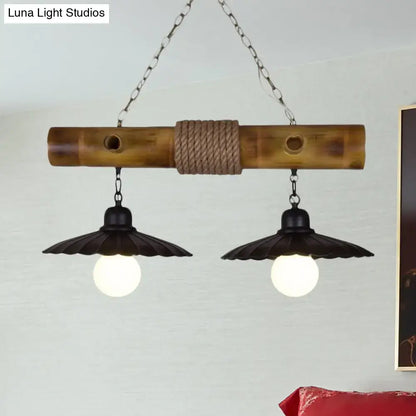 Rustic scalloped hanging lamp with black metal shades and rope-wrapped bamboo center for dining room lighting