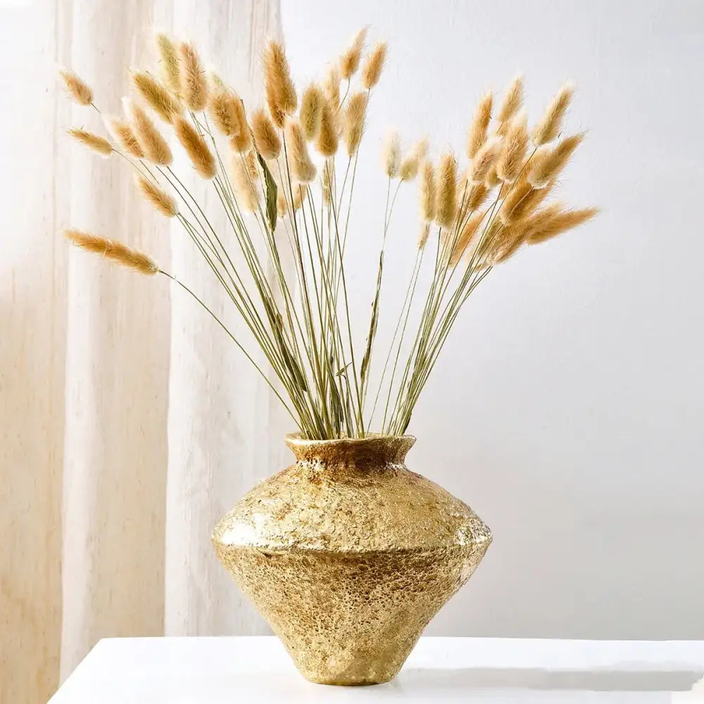 Rustic textured golden vase resin handicraft with flared rim holding dried golden bunny tail grass for living room decorbites golden vase