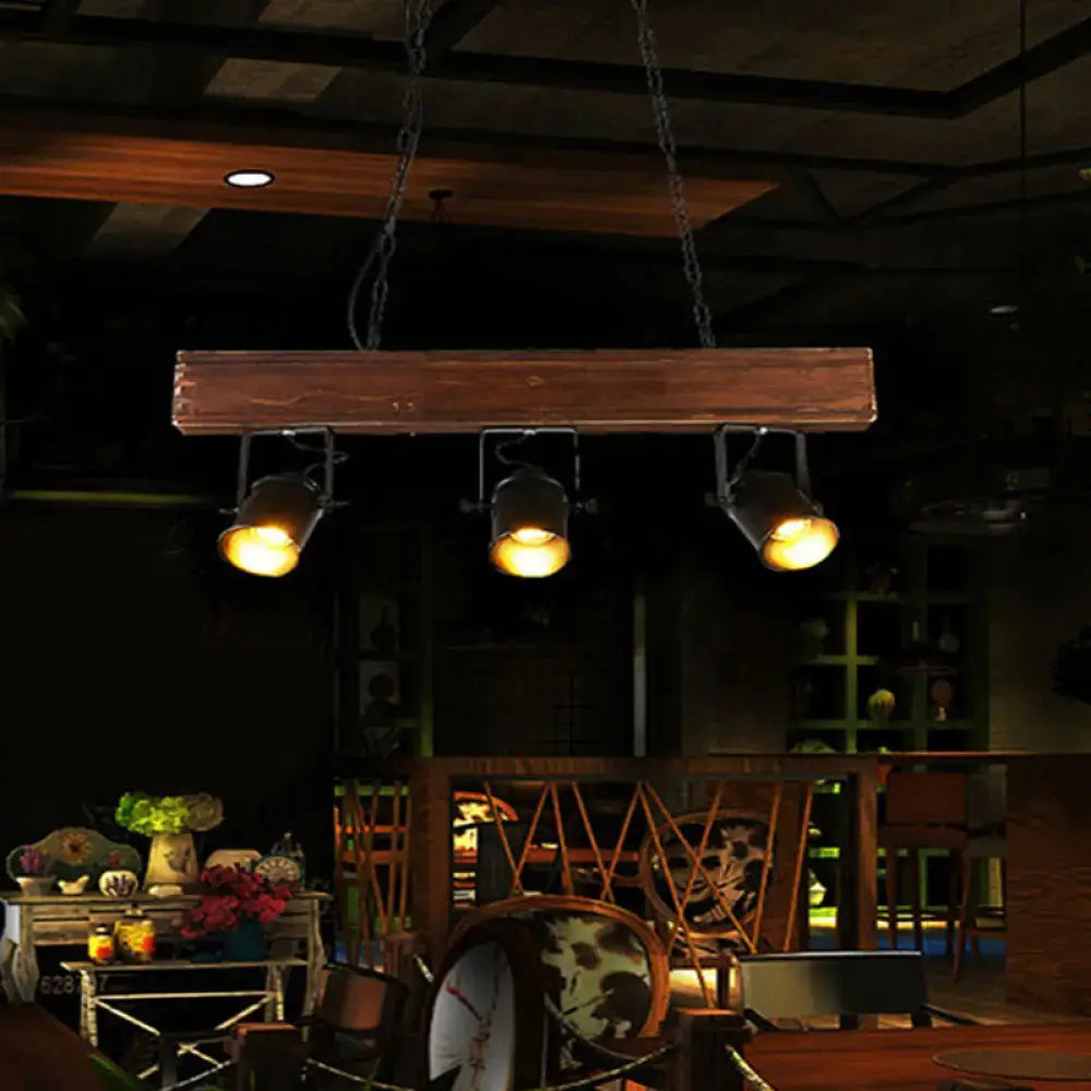 DecorBites vintage 3-headed metal pendant light with black barrel shades on a rustic linear wooden beam