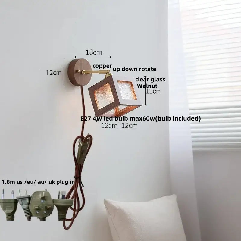 Rustic walnut and brass glass wall light fixture with copper finish, adjustable arm, and clear panels for bedroom use