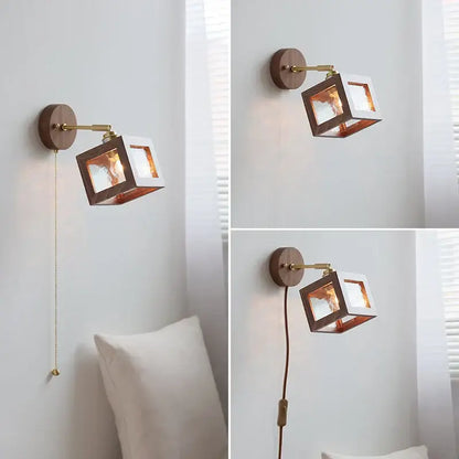 A modern wall light fixture with a square walnut frame, brass accents, and copper interior panels for bedroom use