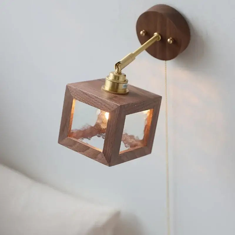 Rustic walnut and brass glass wall light fixture with warm wood cube and frosted panels for bedroom sconce