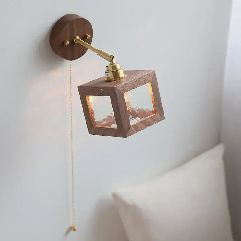 Rustic walnut and brass glass wall light fixture featuring a warm-toned wooden cube design for bedroom use