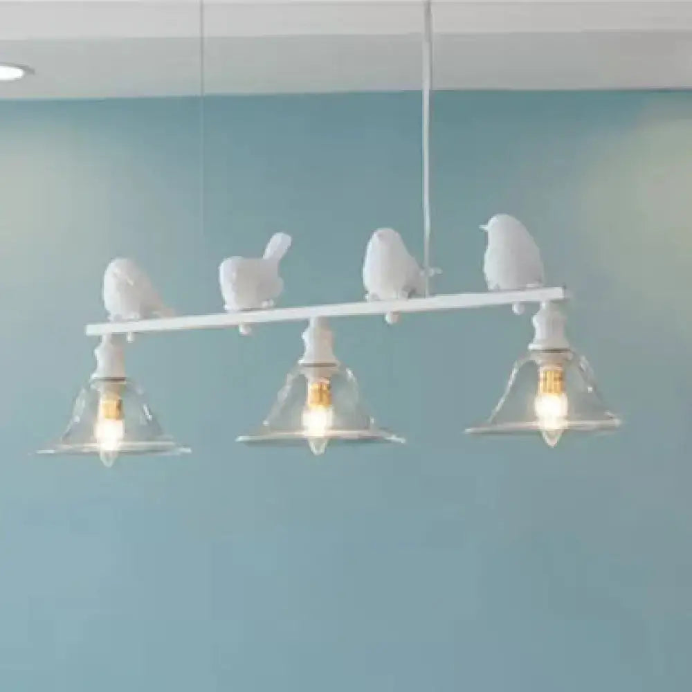 White bird-themed island light fixture with three clear glass shades and sculpted birds on a horizontal bar for balcony