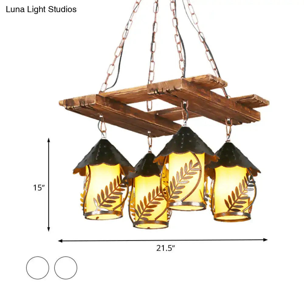 Rustic wooden chandelier with four amber glass shades featuring leaf etchings and black metal roofs with metal arm
