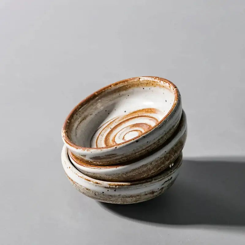 Stack of rustic white speckled ceramic seasoning sauce dishes with subtle spiral interior for decorbites ceramic seasoning use
