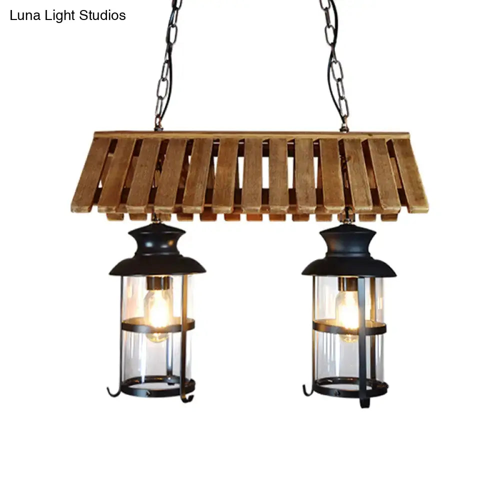 Rustic wood and black antique cylinder island lamp featuring wooden slats and two metal lanterns with clear glass panels