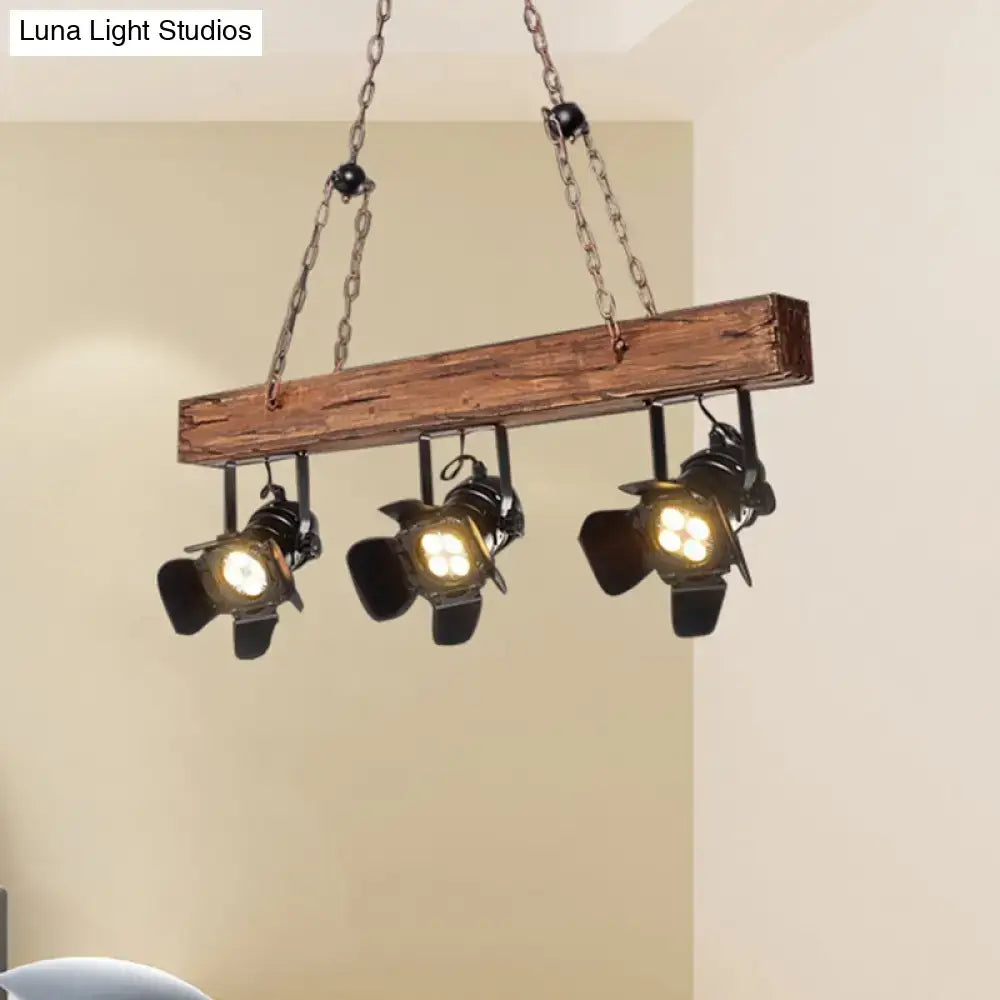 Rustic wood and black metal 3 light island pendant kitchen light with industrial-style wooden beam and three metal spotlights suspended by chains