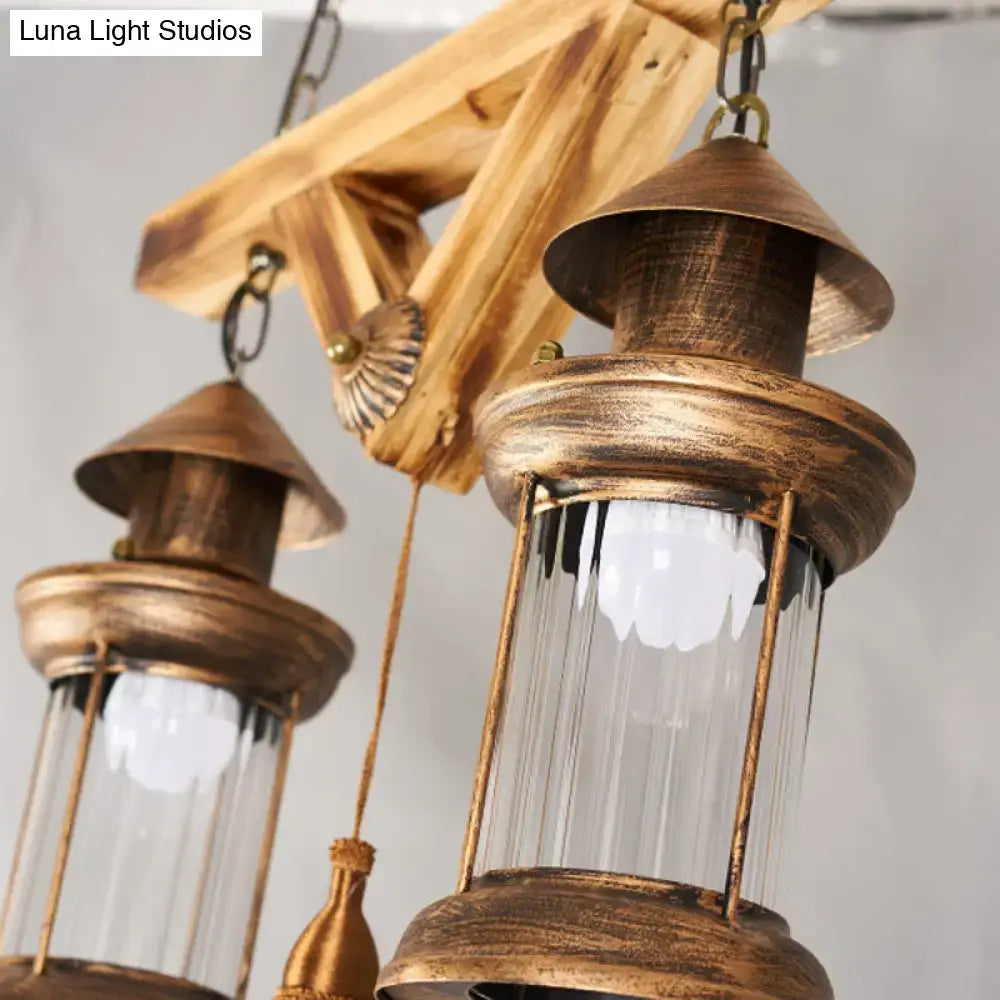 Antique brass light fixture with clear glass panels and rustic wooden frame for a 4-light island light fixture