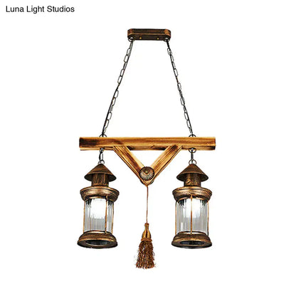 Antique brass 4-light island light fixture with clear glass panels and wooden crossbar by DecorBites bronze coastal