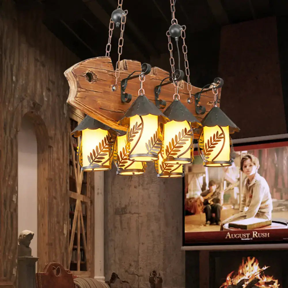 Rustic wood and glass dining room chandelier with three warm glass shades leaf cutouts and black metal arm island lamp