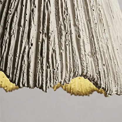 Rustic wood and gray wall light fixture with textured white concrete lampshade and scalloped golden yellow trim
