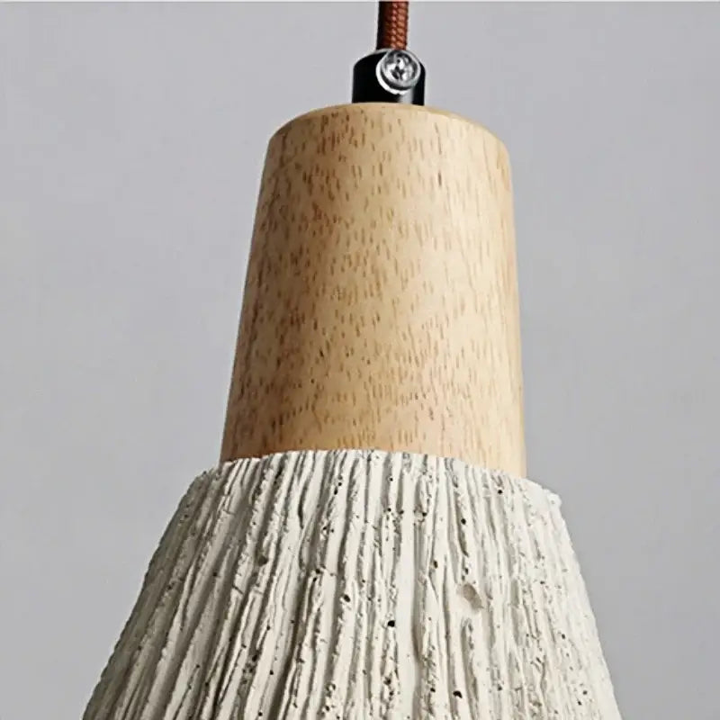 Rustic wall light fixture with natural wood top and textured white concrete shade for bedroom use with pull chain